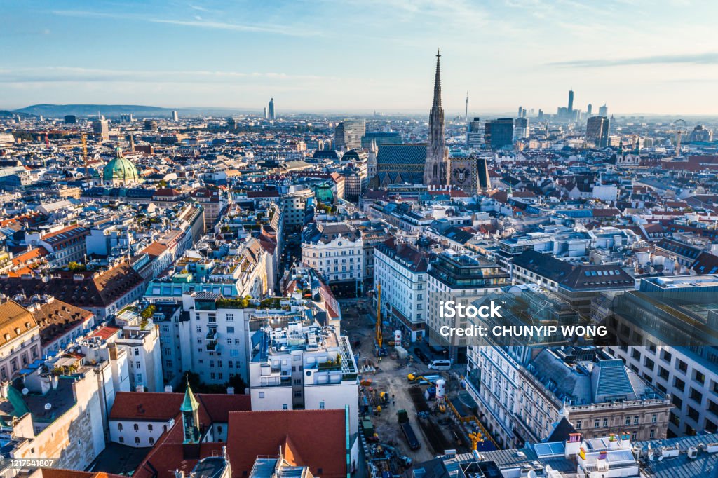 Vienna aerial view in Austria is one of the most famous capital cities of Europe Vienna aerial view in Austria is one of the most famous capital cities of Europe. Flying by above Danube River, the historic city centre feat. old buildings around the downtown Danube River Stock Photo