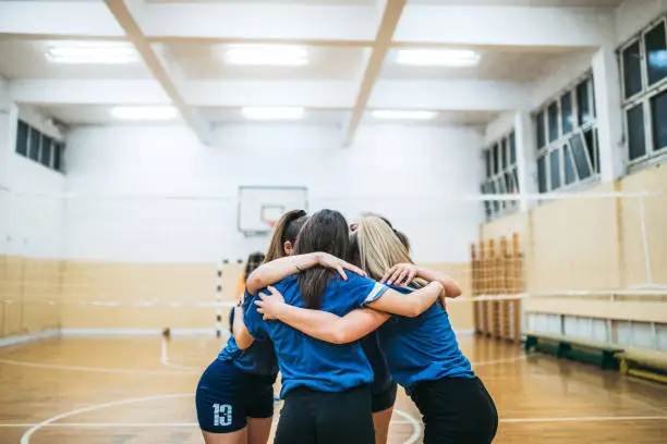 Female volleyball players celebrating between matches.