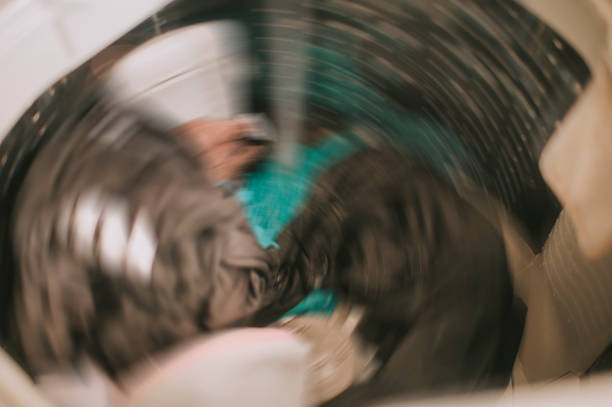 istock Top view of a washing machine drum during spinning clothes. Top loading washing machine washes laundry 1217543840