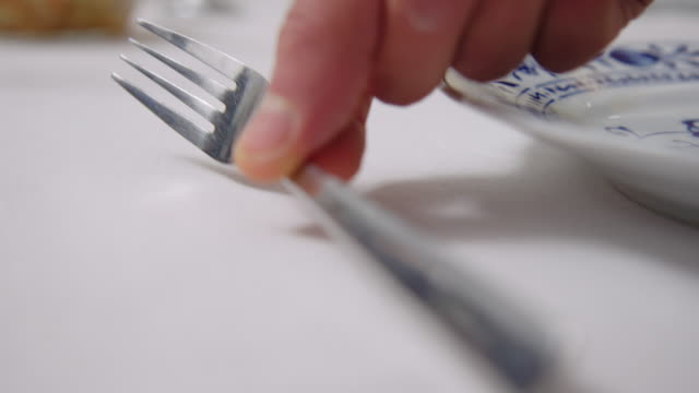 Close-up of a man setting dining table at cooking class