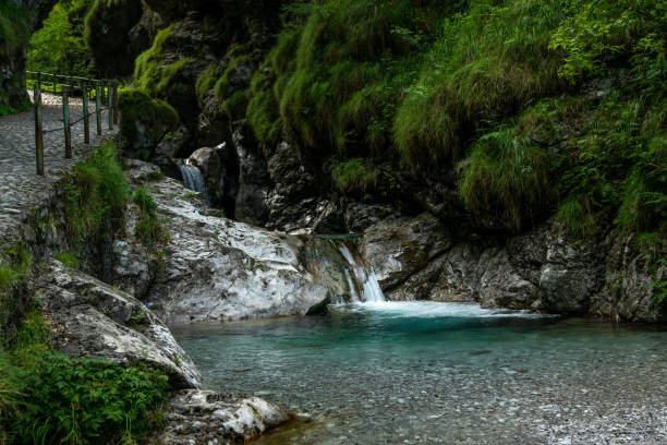 istock waterfalls with clear green water 1217549344