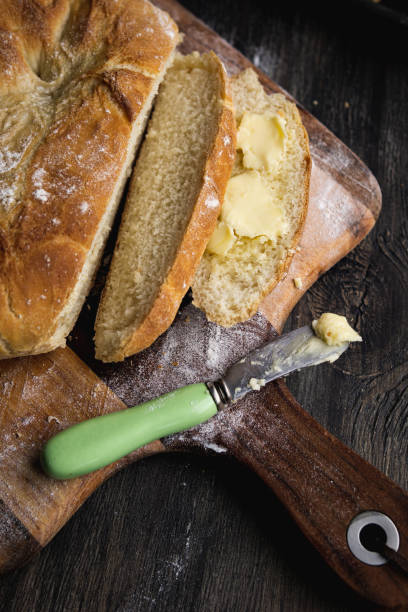 istock Home made crusty bread on a wooden paddle. 1217550841