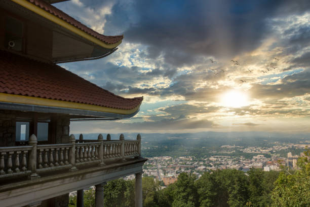The Reading Pagoda Overlooking the City at Sunset with a beauty cloudscape and birds in the sky.