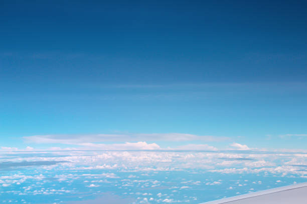 istock Vast bright blue sky view with clouds from airplane window, copy space 1217551977