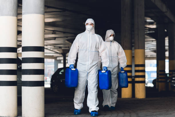istock medical workers in protective suits carrying barrels with disinfectant 1217552323