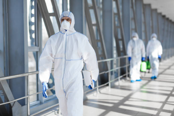 istock Virologists wearing protective hazmat suits making researches 1217553115
