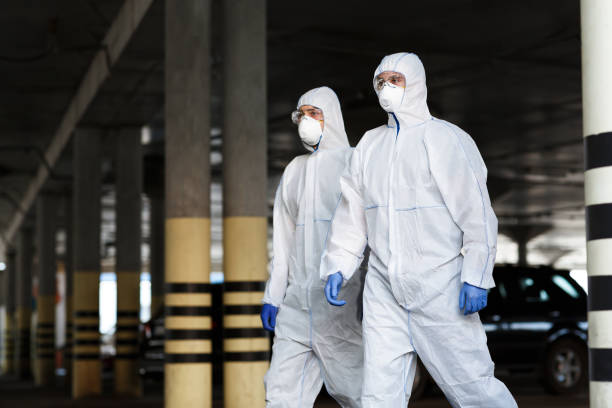 istock Medical workers in protective mask and suits going in empty city 1217553370