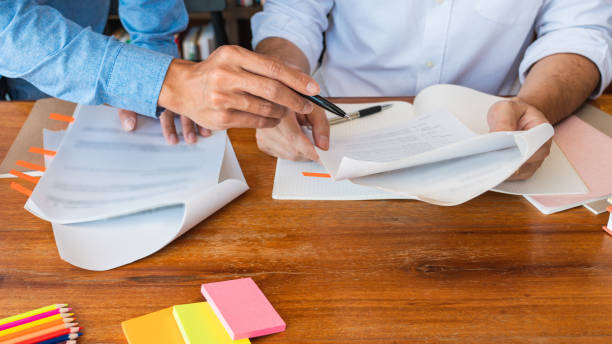 istock College tutor helps friend teaching and learning for a test or an exam catching up, education and school encouragement concept. 1217553428