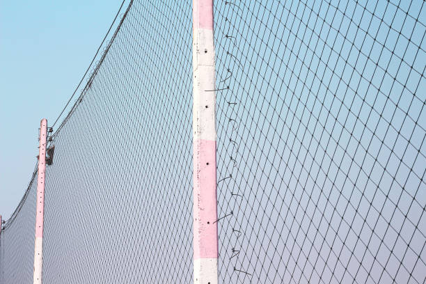 istock Pole with football protection net on bright blue sky background 1217553710