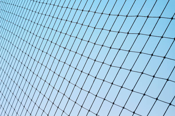 istock Football protection net on bright blue sky background 1217553762