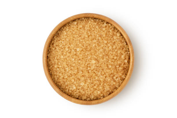 istock Brown sugar in wooden bowl on white background 1217554918