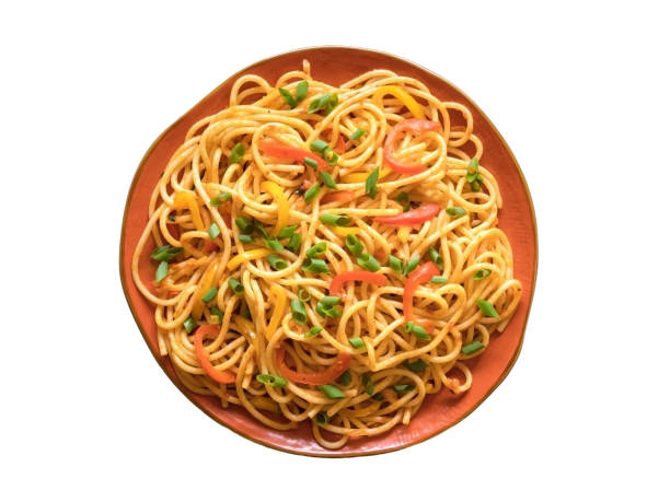 istock Isolated Schezwan Noodles with vegetables in a plate 1217555134