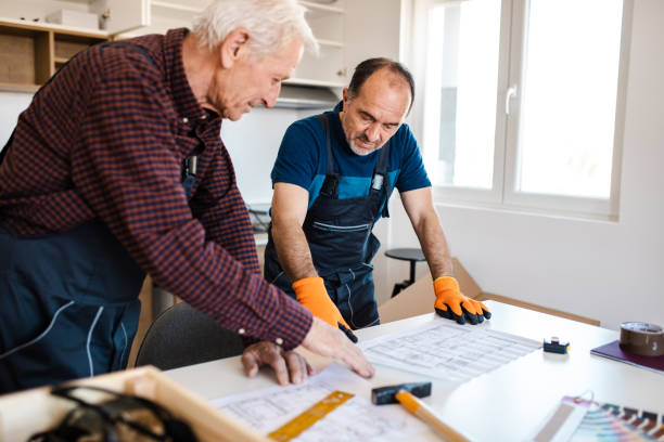 istock Determined senior construction workers analyzing blueprint of house and thinking about changes they need to made 1217556111