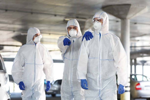 istock Frightened Man in virus protective suit showing with finger on something 1217556241