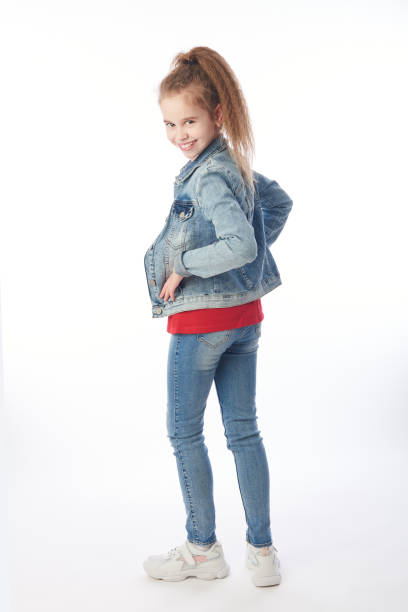 istock Young girl wearing denim looking backwards 1217558111