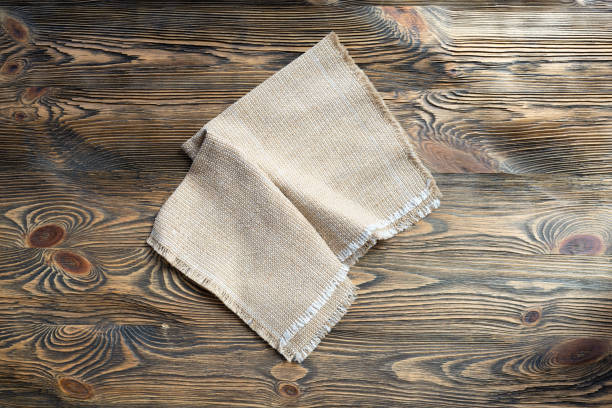Linen napkin on wooden table, minimalism, rustic stock photo