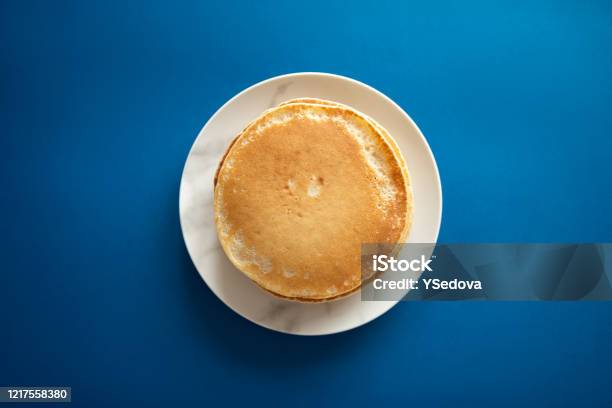 Fresh Pancakes On A White Dish Classic Blue Background 2020 Stock Photo - Download Image Now