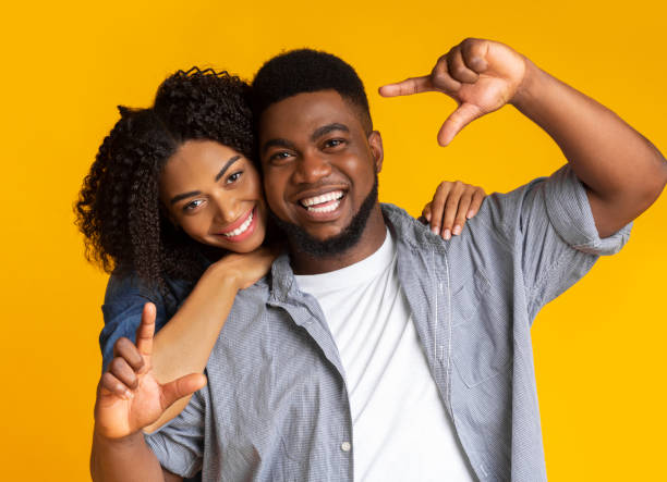 istock Capturing happy moments. Romantic black couple making frame with hands 1217558470