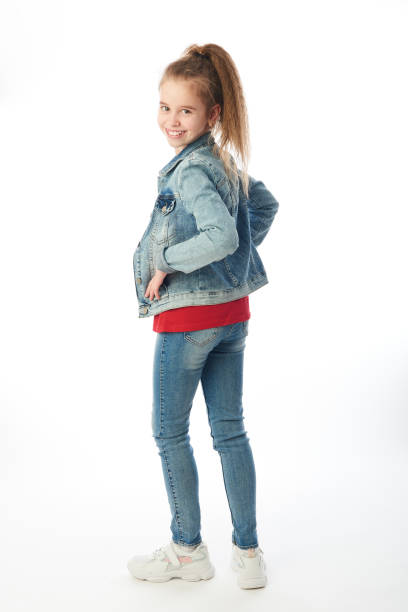 istock Young girl wearing denim looking backwards 1217558482
