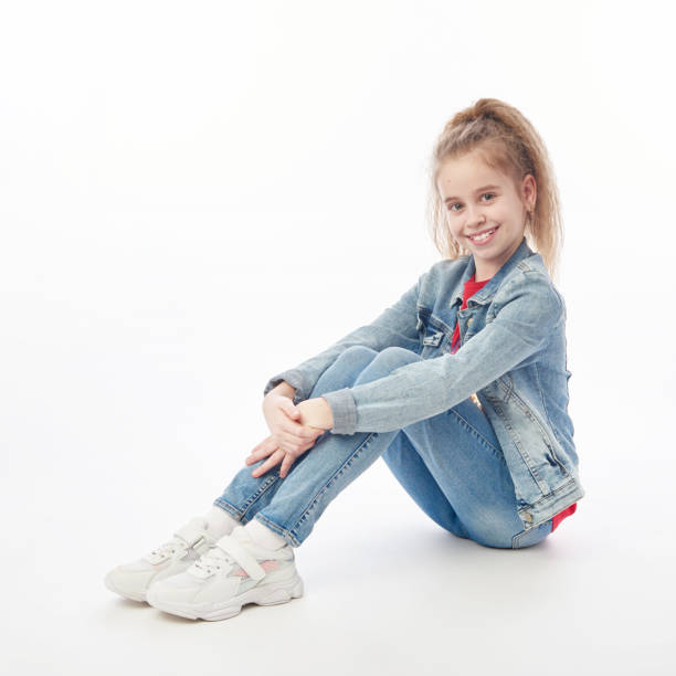 istock Young girl wearing denim coat and jeans 1217558589