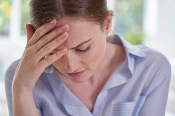 istock Sad Young Woman Suffering From Depression With Head In Hands 1217558608