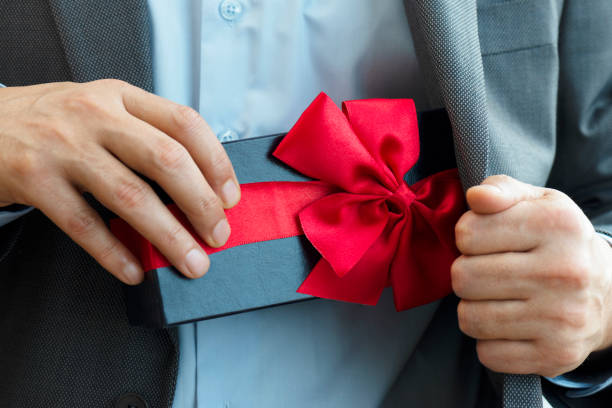 istock Businessman giving Gift Box 1217559675