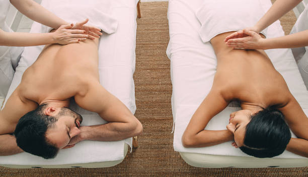istock Beautiful mixed race couple getting massage at beauty spa. 1217559692