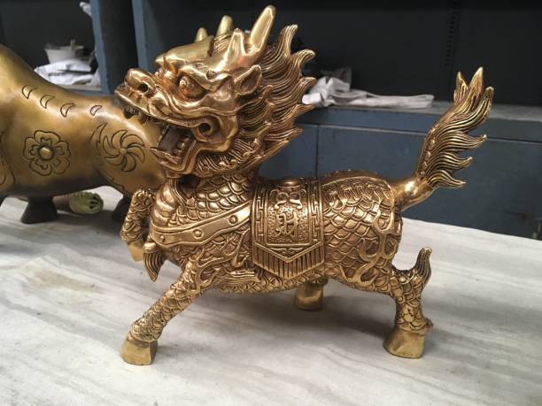 Golden Chinese Lion sculpture displayed for SALE in an antique market