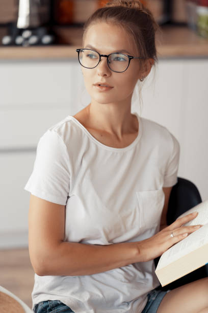 istock Cute girl is reading a book 1217561157