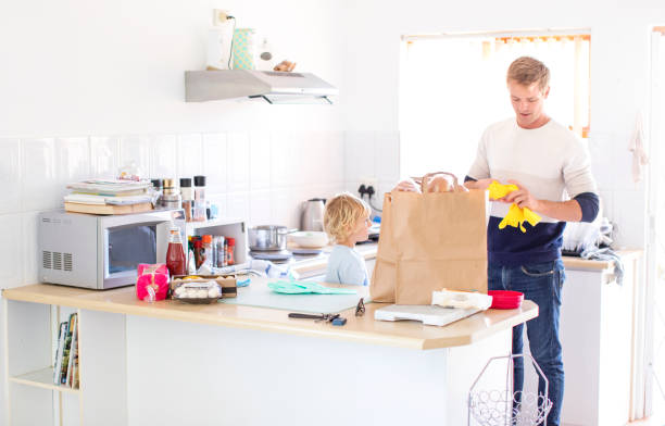istock a Father and son disinfecting the groceries. 1217563131