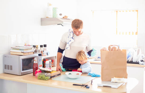 istock a Father and son disinfecting the groceries. 1217563180