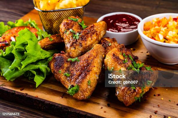 Barbecue Chicken Wings And Vegetables On Wooden Board Stock Photo - Download Image Now