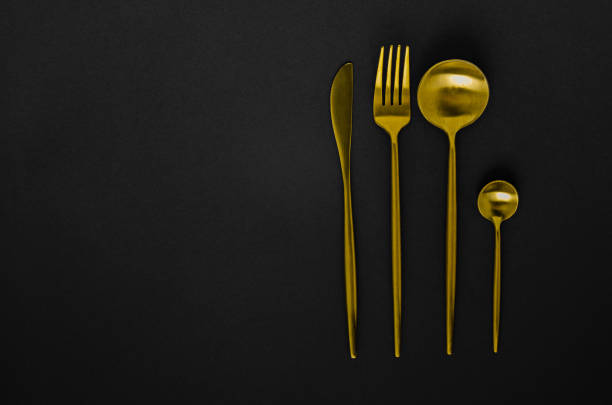 istock Set of golden instruments - a spoon, fork, knife, teaspoon. 1217566149