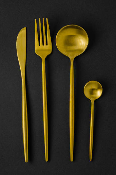 istock Set of golden instruments - a spoon, fork, knife, teaspoon. 1217566171