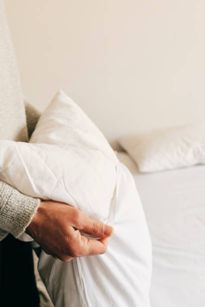 istock caucasian man making the bed 1217566696