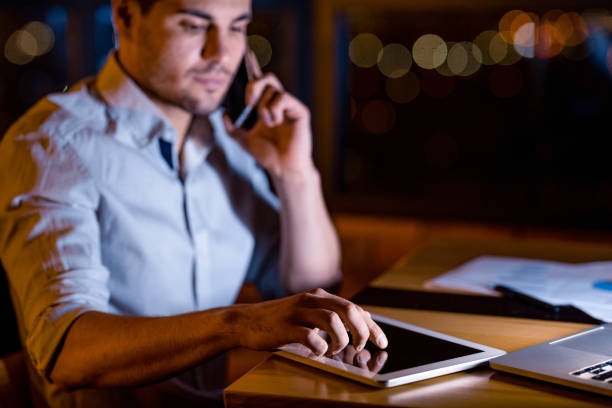 istock Serious Businessman Using Tablet Computer Sitting In Office At Night 1217566906