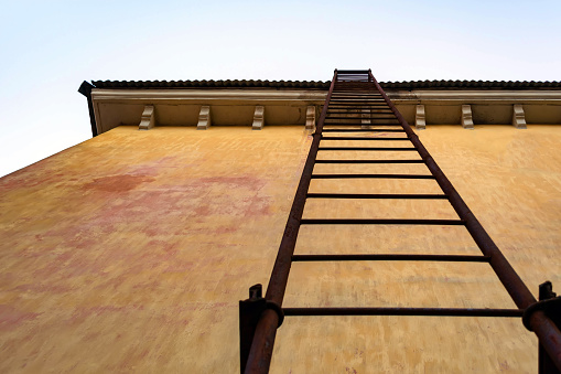 straight fire escape on the wall of an old building.