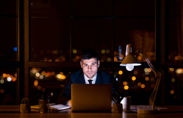istock Confident Entrepreneur At Laptop Working Sitting In Office At Night 1217567981