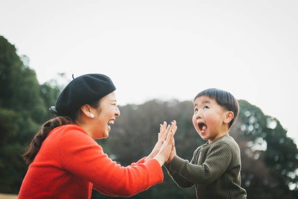 mother and son doing a high-five - family cheerful family with one child texas imagens e fotografias de stock