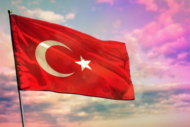 istock Fluttering Turkey flag on colorful cloudy sky background. Prosperity concept. 1217568679