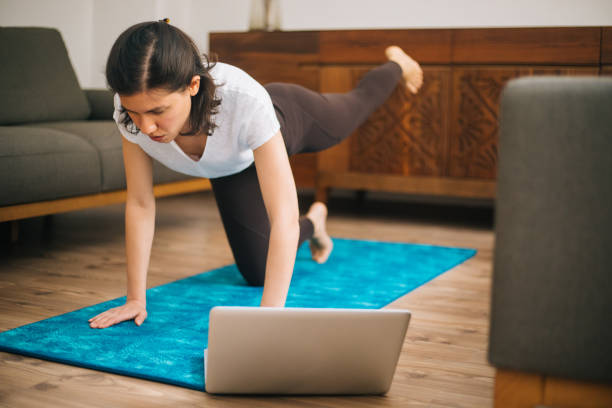 istock Young sporty attractive woman practicing at home 1217568727