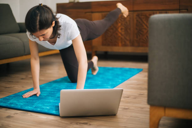 istock Young sporty attractive woman practicing at home 1217568729