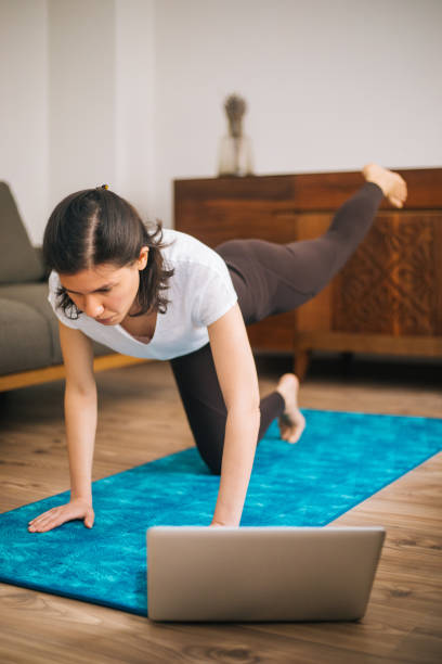 istock Young sporty attractive woman practicing at home 1217568888