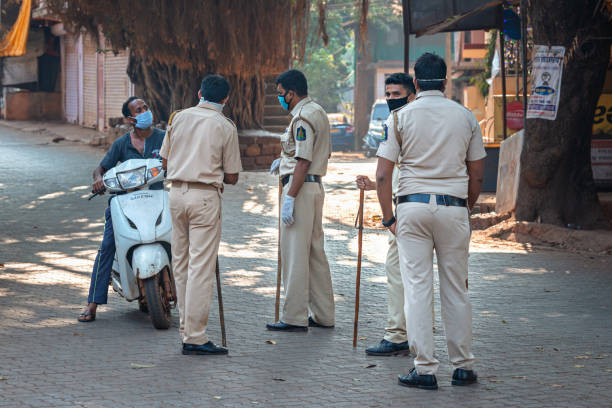 03/28/2020 India, GOA, Arambol, Police (CRPF) personnel stops and controled commuters during Indian lockdown and curfew as preventive measure against COVID-19 coronavirus 03/28/2020 India, GOA, Arambol, Police (CRPF) personnel stops and controled commuters during Indian lockdown and curfew as preventive measure against COVID-19 coronavirus maharashtra photos stock pictures, royalty-free photos & images