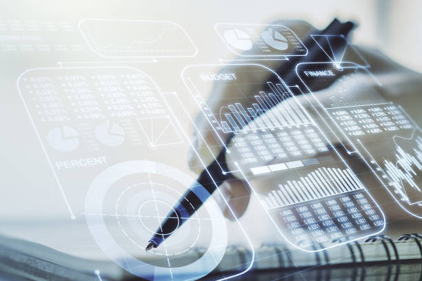 istock Double exposure of abstract creative statistics data hologram with woman hand writing in notepad on background, analytics and forecasting concept 1217573220