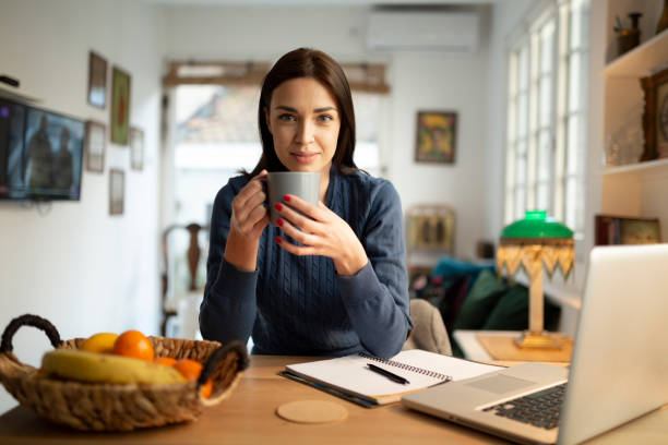 istock Beautiful young woman working from home 1217573386