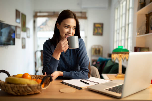 istock Beautiful young woman working from home 1217573389