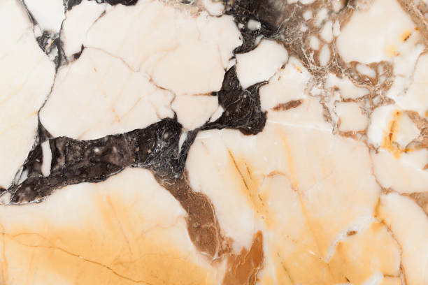 istock Natural yellow black marble wall panel, close up 1217573643