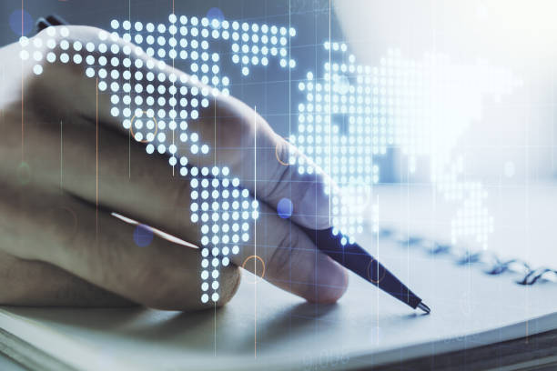 istock Multi exposure of abstract graphic world map and man hand writing in notepad on background, connection and communication concept 1217575368