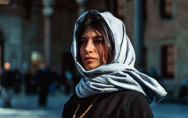 istock Attractive arabic woman standing near mosque 1217576273